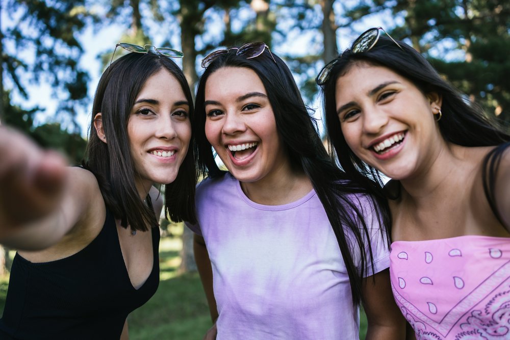 People, Clothing, Smile, Face, Head, Hand, Plant, Facial expression, Purple, People in nature, Flash photography