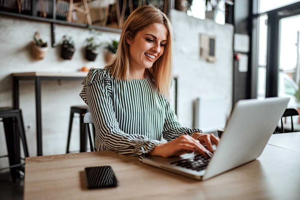 Business, Computer, Smile, Table, Personal computer, Furniture, Laptop, Netbook, Sleeve, Interior design